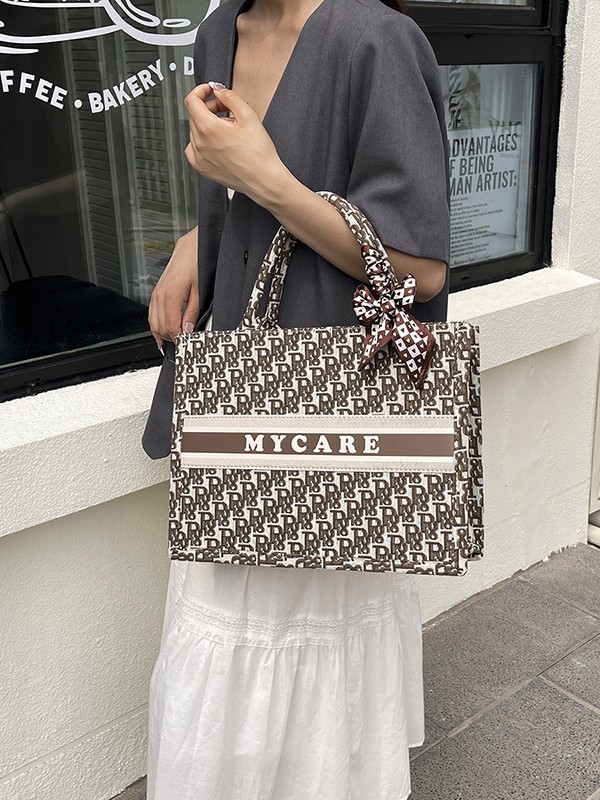 Bolsos bordados de alta calidad para mujeres 2026 nuevas letras de tela transfronterizas retro bolsas de mano de transporte de gran capacidad