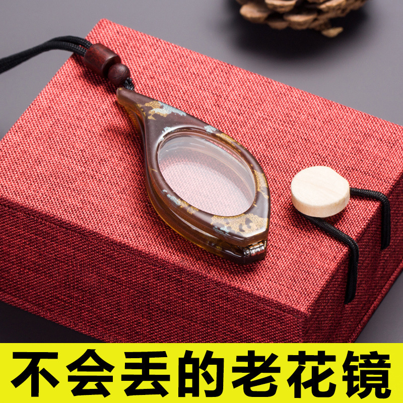 新型の首掛け式の老眼鏡の女性のネックレスのアクセサリの男性の折り畳みの老眼鏡の露店の軽い携帯の老人の鏡