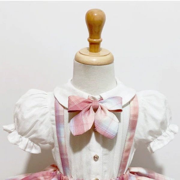 White doll with bow, doll collar