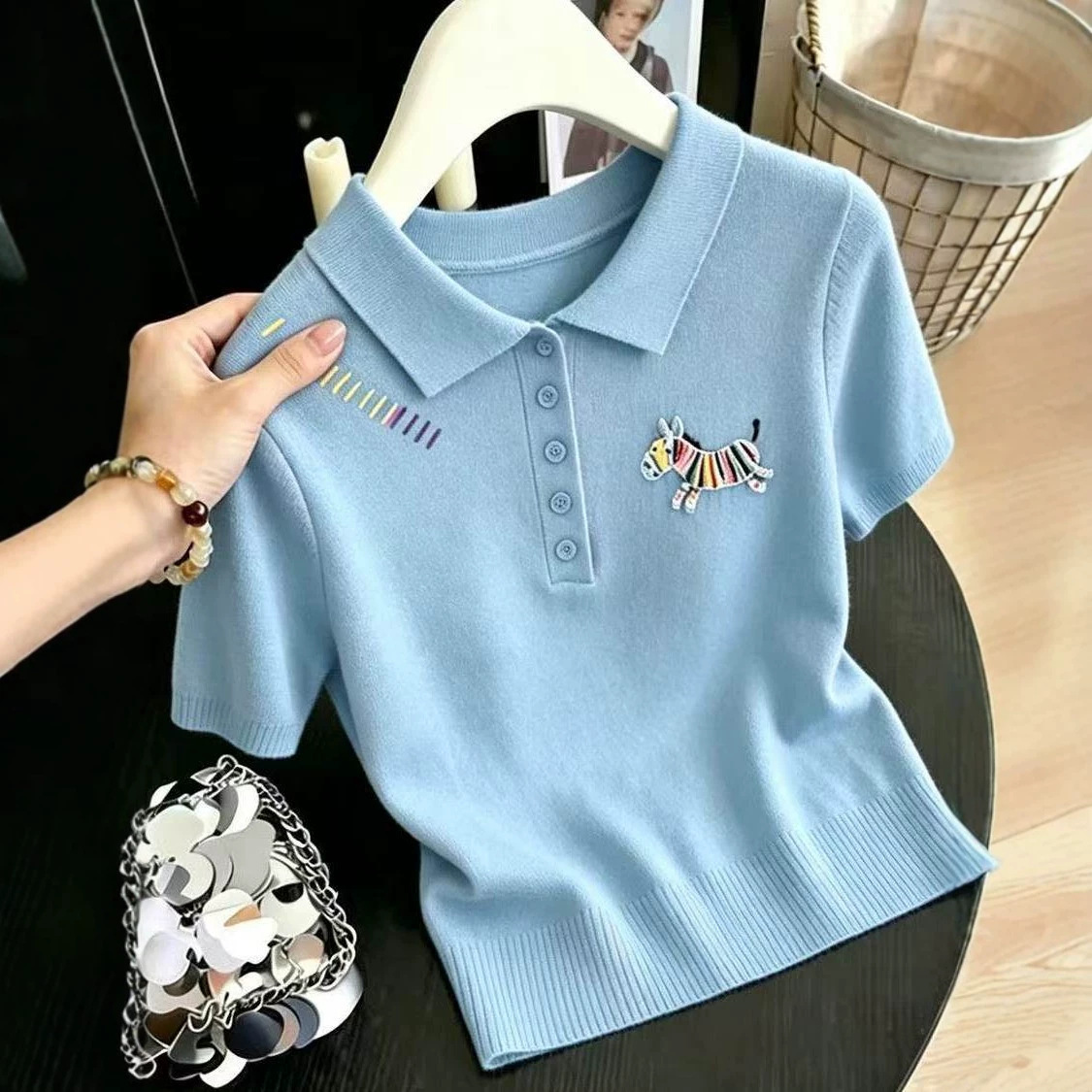 Áo thun polo nữ tay ngắn cổ bẻ thêu họa tiết, chất liệu len lụa mát lạnh, form ôm nhẹ — màu xanh nhạt