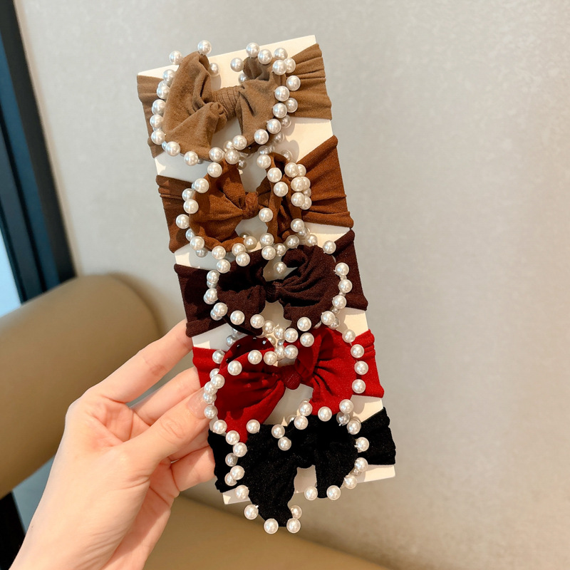 Arco de perla máscara anillo de cabello femenina baja cuerda de cabello bola adornamiento de cabello correa de cuero cuerda de cabello al por mayor