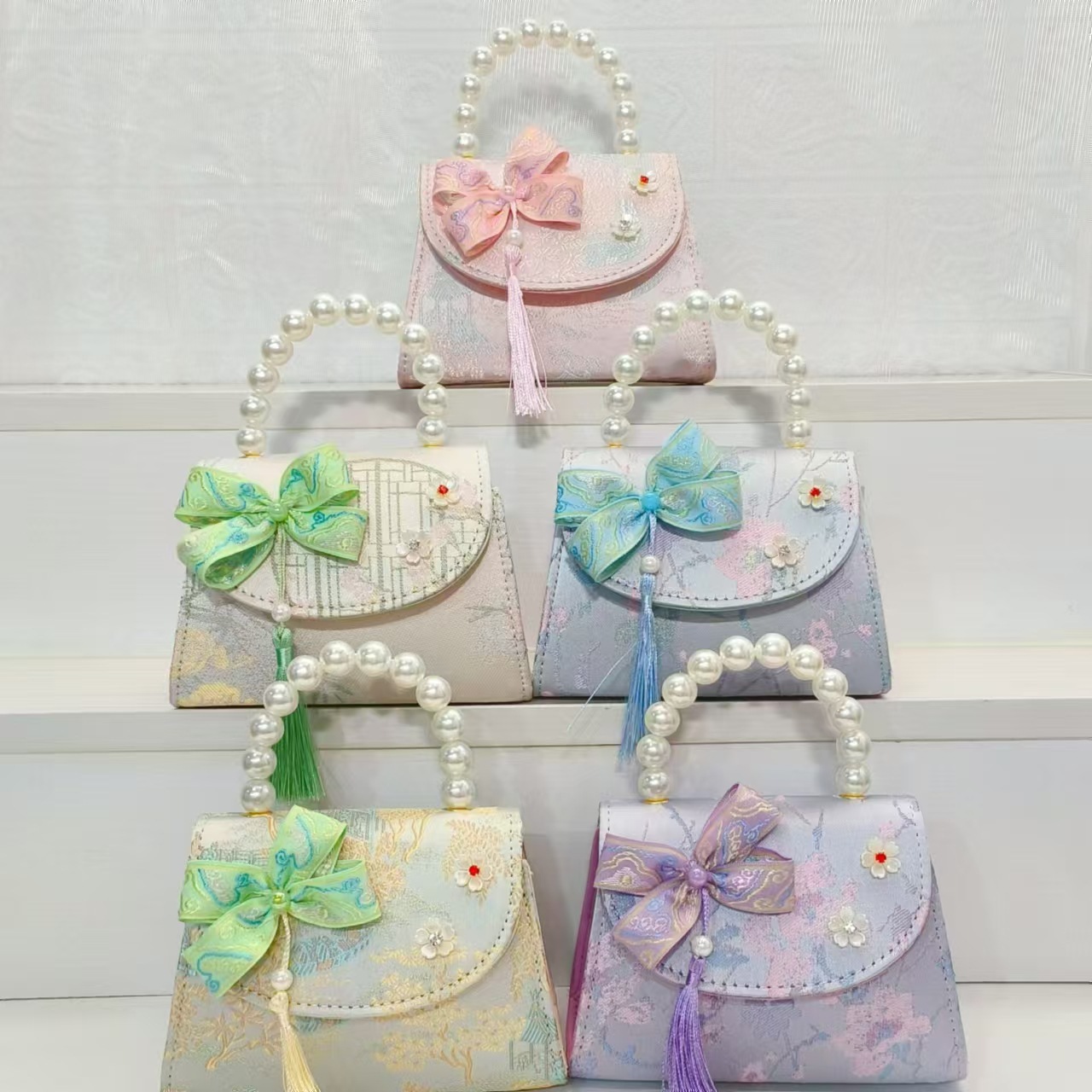 Bolsas de niños arco de estilo chino borda de niña pequeña princesa perla bolsa de cambio de mano al por mayor