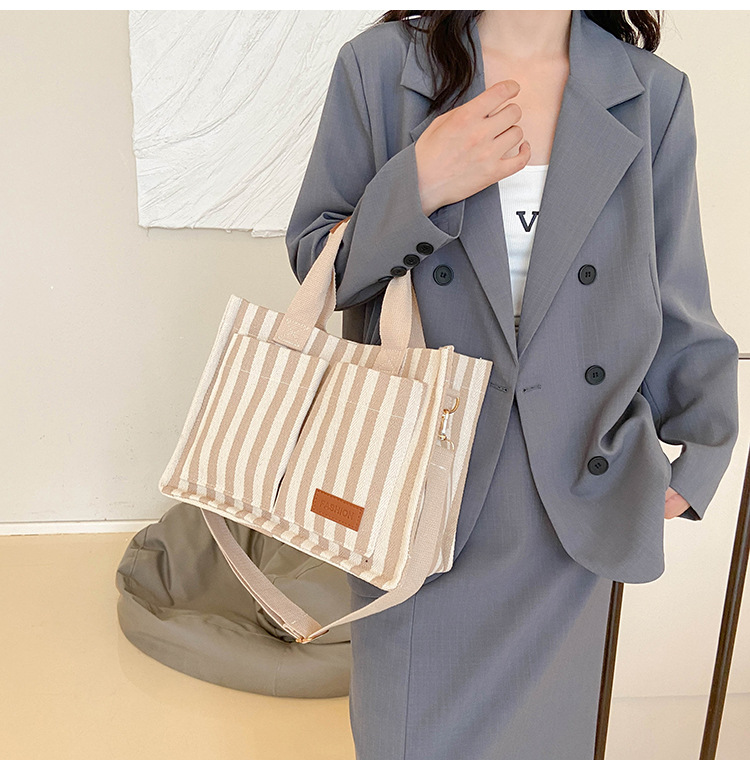 Popular striped canvas 2024 new commuter large capacity casual fashion personalized hand-held crossbody tote women's bag_voghion.com