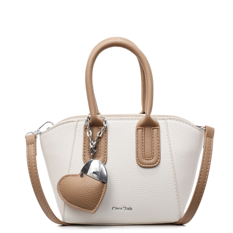 Bolso de cubo portátil de estilo caliente de moda para mujer 2025 nuevo bolso de hombro retro de nicho bolso de mensajero de moda de todo fósforo de moda