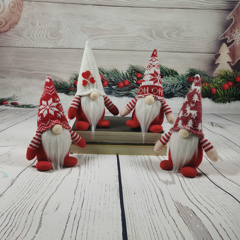 国境を越えたクリスマスニット帽人形の座り方に顔のない人形のショーウインドーがクリスマス舞踏会パーティーの装飾を飾っている|undefined