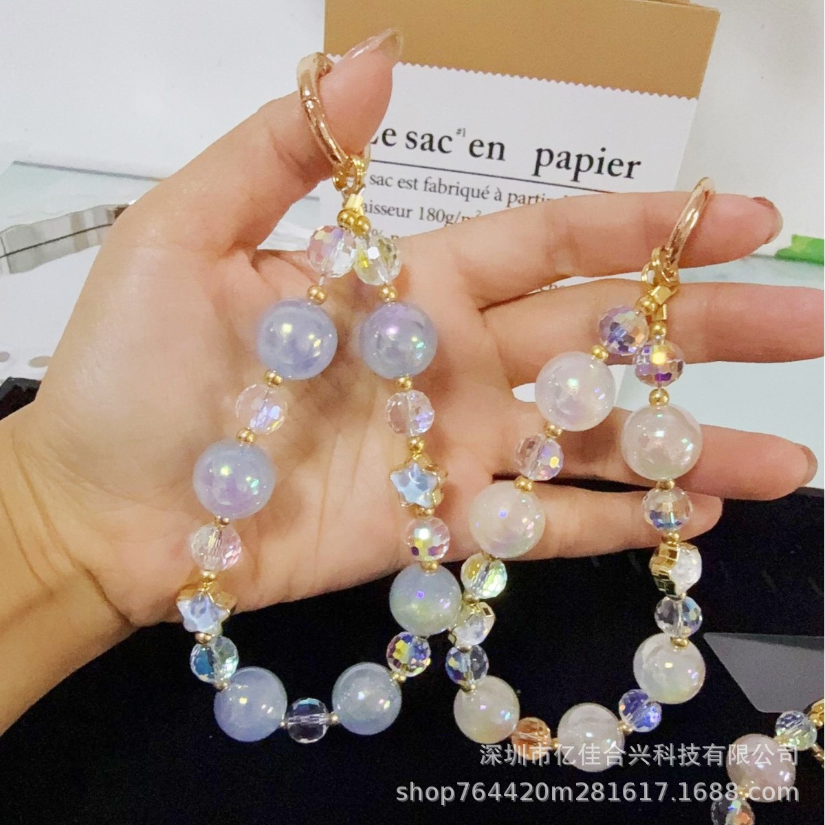 Mayorista cadena de teléfonos móviles sensación de alta calidad estereoscópica bola pentagonal llave colgante perla de teléfono móvil colgante pulsera nuevo