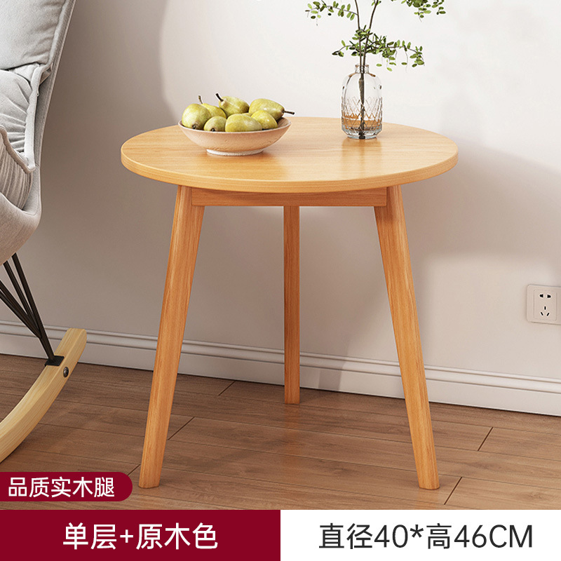 Sofá de la sala de estar pequeña mesa redonda doméstica, estante de cabecera de cama moderno y minimalista, mesa de té creativa con balcón