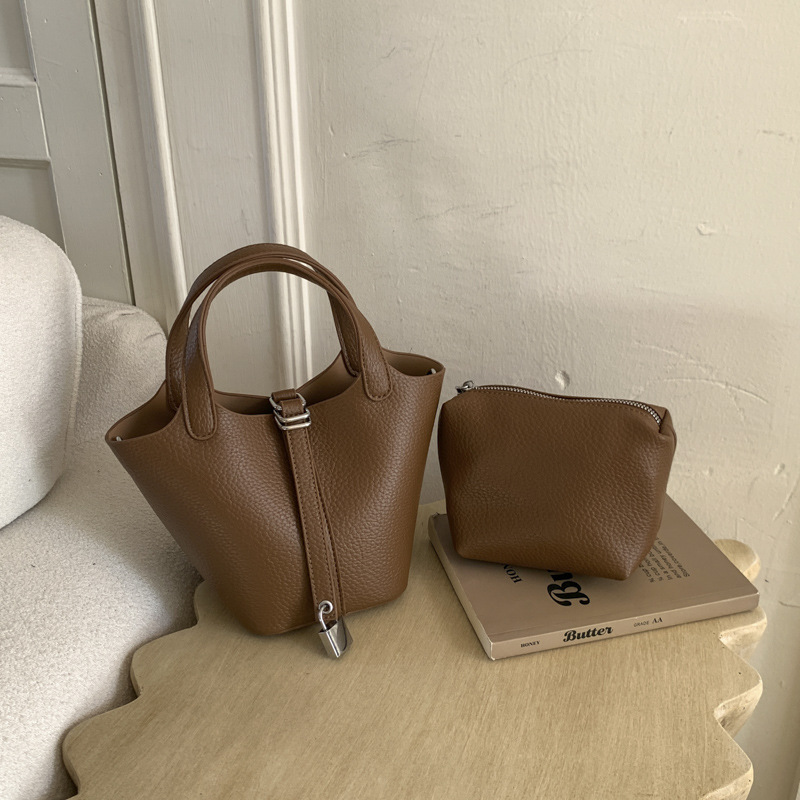 Cestas clásicas de platos bolsas de cubo de mano nicho coreano de litchi de textura alta moda versátil bolso de mochila