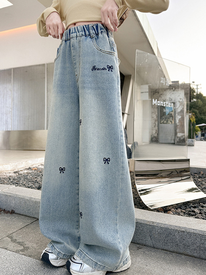 女の子の大きい子供のジーパンの春秋は2025新型の韓国版の洋風のカジュアルな広い足のズボンの女の子の春の金のゆったりしているズボンを詰めます。