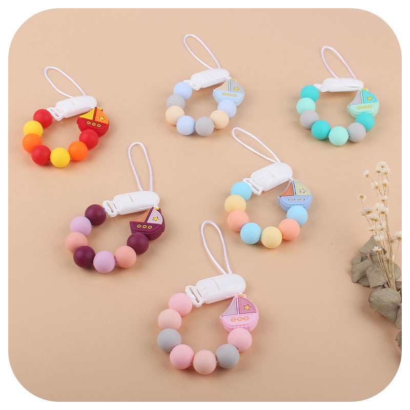 El Comercio exterior nuevo bebé suministros Cadena de chupete de silicona vela dientes de juguete de silicona de dibujos animados Cadena de molienda