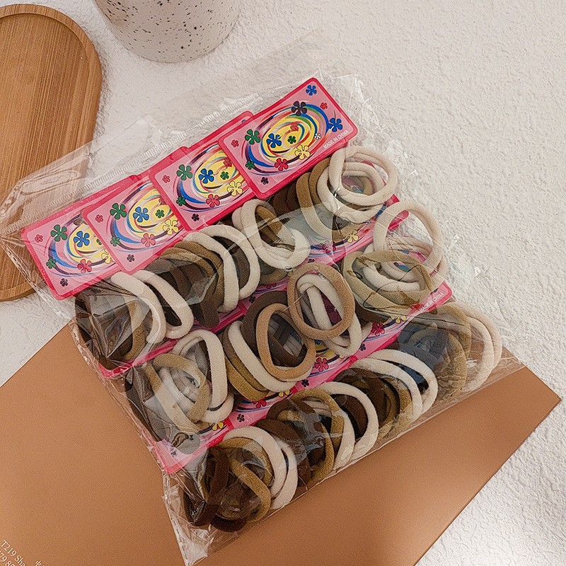 100-pieza de alta elástica sin costura toalla anillo de color Banda de pelo cuerda de pelo de color caramelo banda de goma cubierta de cuero cuerda de pelo al por mayor