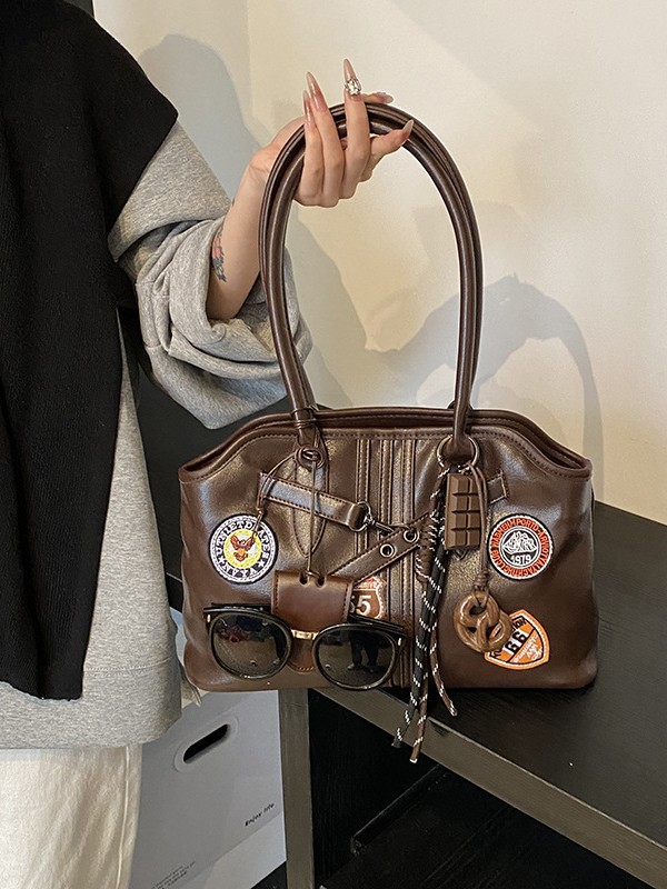 Insignia retro de gran capacidad hombro brazo bolso para mujeres 2025 nueva moda transfronteriza alta textura bolso