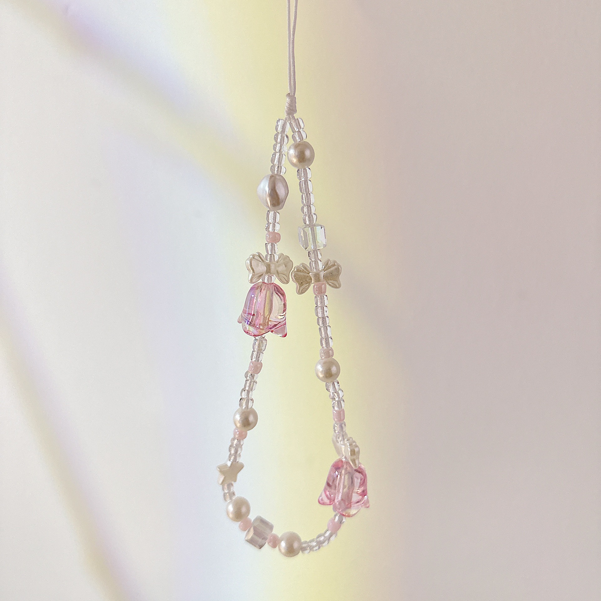 Aplicable cadena coreana orquídea de campana cadena de muñeca arco cuentas de caso de teléfono móvil colgante anti-perdida colgar pulsera trenzada