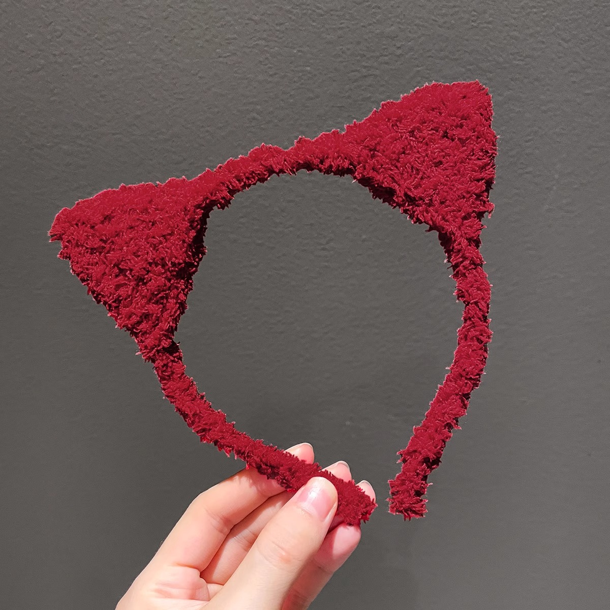 A burgundy cat ear headband