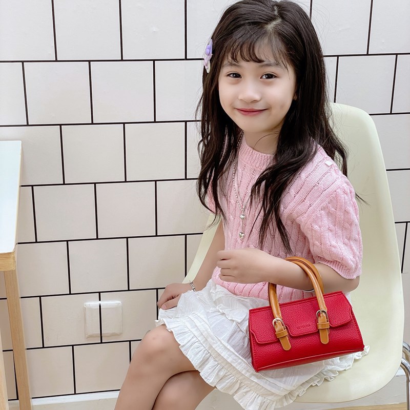 2025 nuevo bolso para niños de comercio exterior, bolso de niña popular de moda coreana, bolso de mensajero para bebé de color sólido de estilo extranjero
