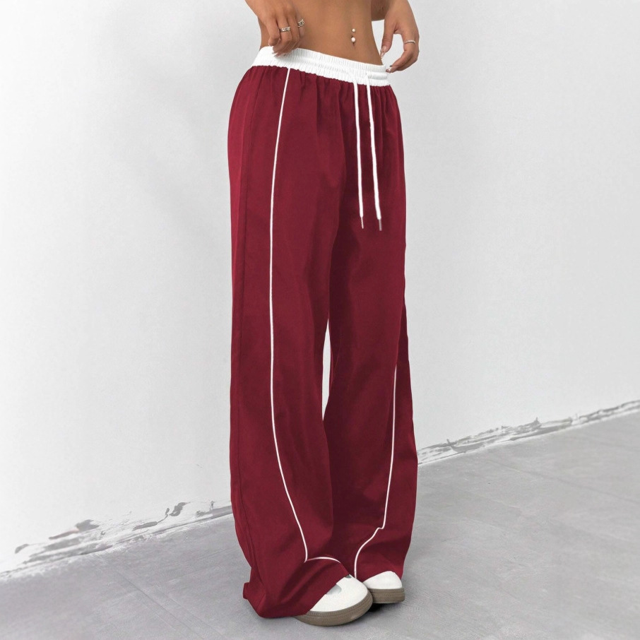 Europa y los Estados Unidos transfronterizos de otoño y invierno 2025 moda nuevos pantalones deportivos negros de mujer sueltos ociosos nichos de piernas largas