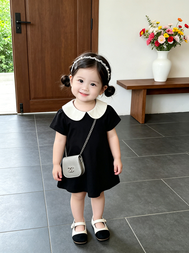 Bebé de verano vestido de estilo Hepburn bebé negro y blanco contraste muñeca cuello de manga corta A vestido de moda ropa infantil