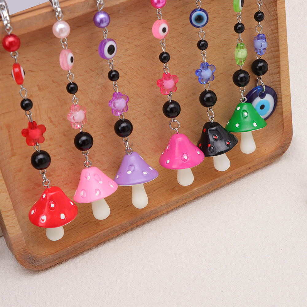 La versión coreana transfronteriza de la joyería de llavero de setas de color, la resina de dibujos animados, el ojo creativo del diablo, el bolso, el colgante de accesorios