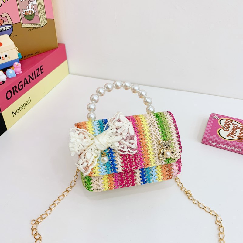 2025 verano nuevo arco de paja bolsa de perla portátil inclinada pequeña fragancia bolsa de moda para niños mochila para niñas