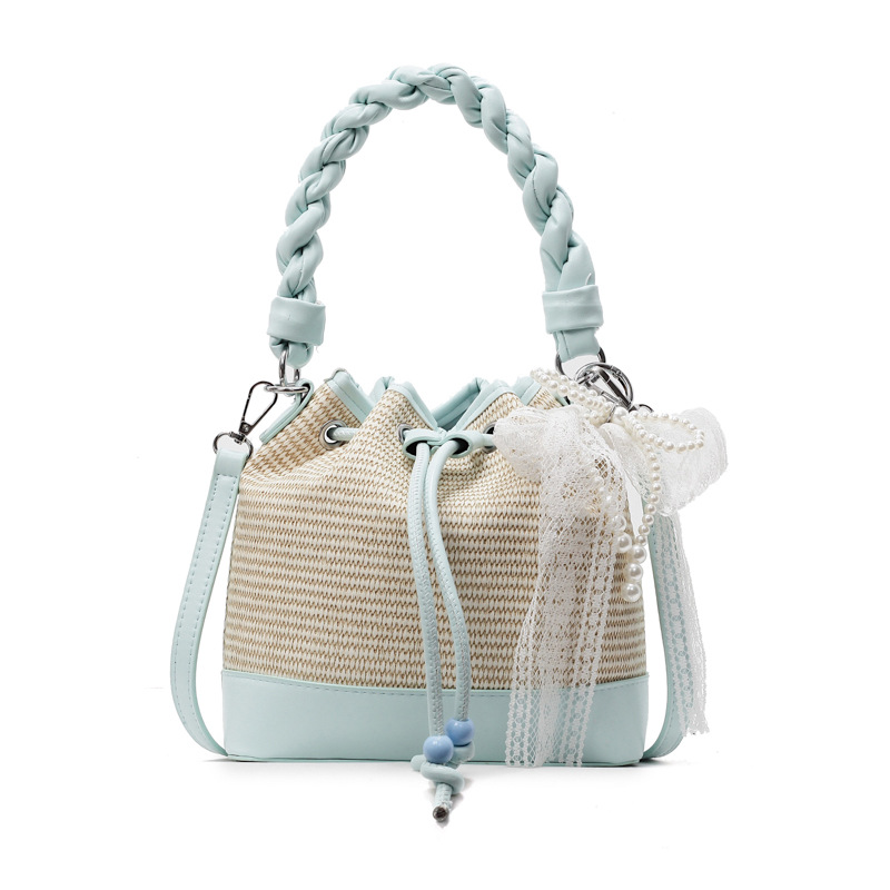 Bolso de cubo de mano de alta gama para mujer 2025 nuevo bolso de hombro con cordón de patrón tejido de moda bolso de mensajero de viaje de todo fósforo