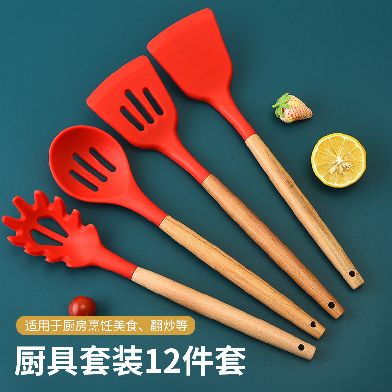 Traje de utensilios de cocina de silicona transfronteriza mango de madera sartén antiadherente de 12 piezas pala de cocina cuchara suministros de cocina espátula de silicona conjunto completo