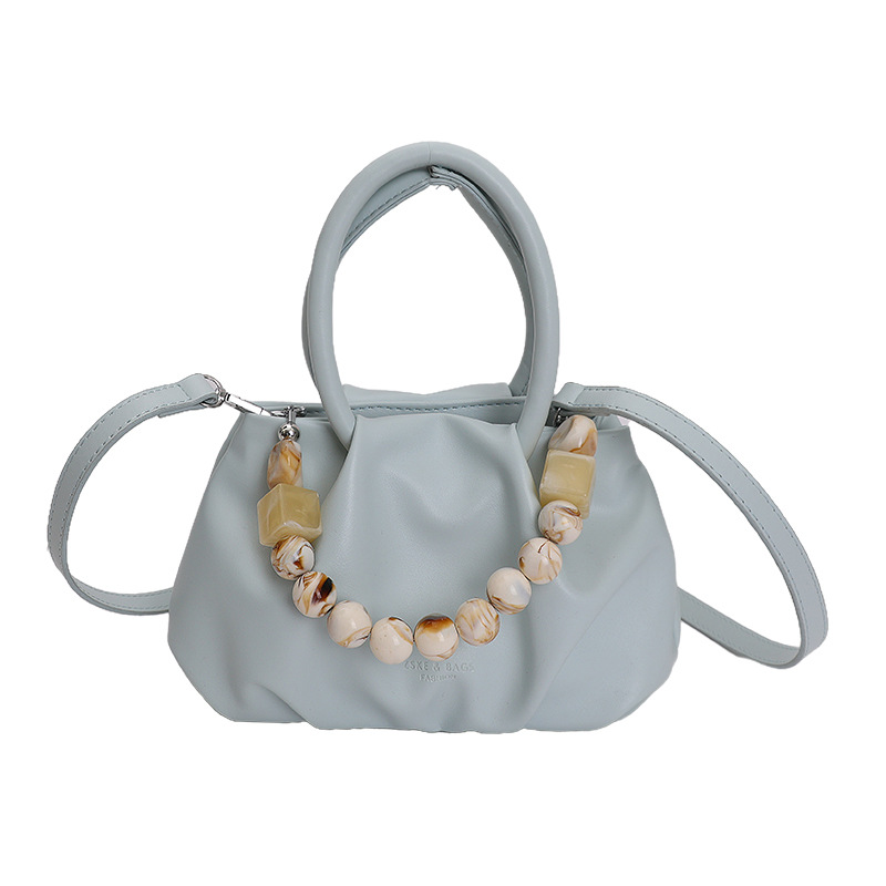 Alta sensación de mano pliegueada nube bolso de cubo para mujeres 2026 nuevo nicho de lujo ligero de moda perla bolsa de mochila