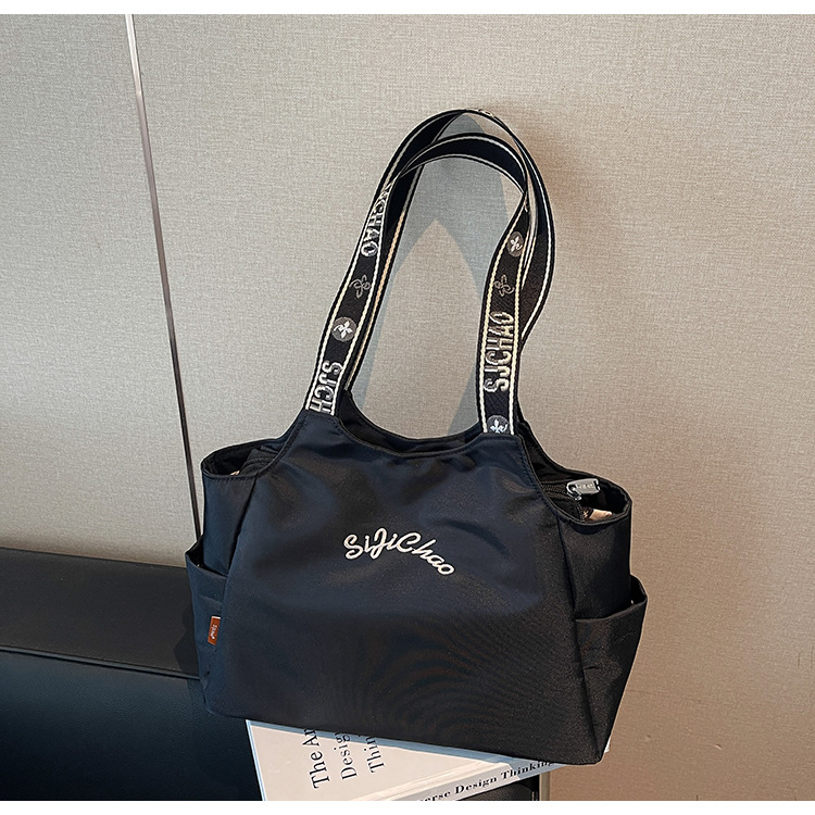 Bolsas de lona de moda de gran capacidad para mujeres 2026 nueva textura bordada letras bolsas de hombro de viaje simple bolsas de mano