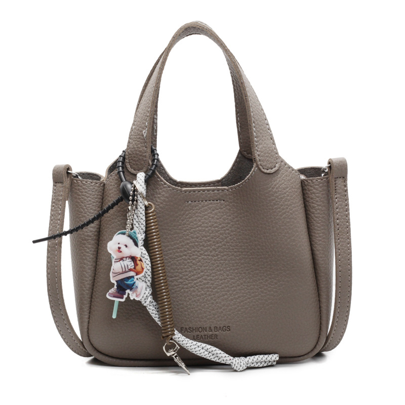 Bolso de cubo de mano transfronterizo sentido de alta gama para mujer 2025 nuevo bolso de mensajero de un solo hombro simple y versátil bolso de canasta de verduras de nicho