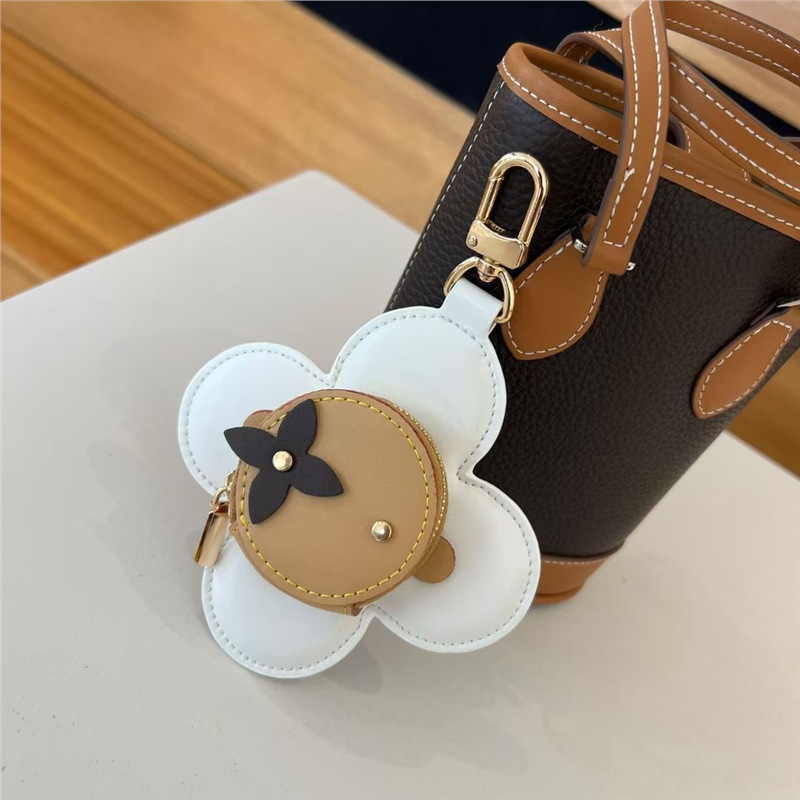 2025 nuevo solar flor de llaves bolsas de monedas bolsas de nicho de cuero bolsas colgantes bolsas de polvo de auriculares