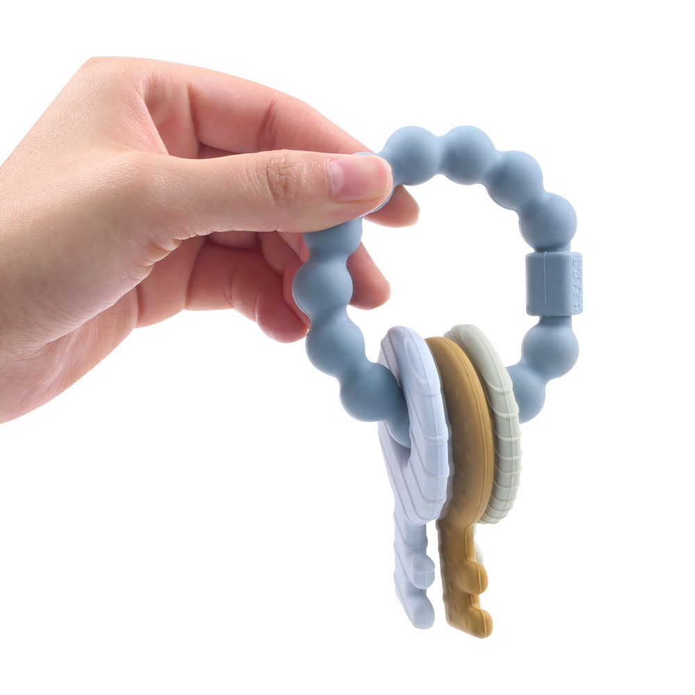 Bebé de calidad alimentaria silicona teether pulsera mordida clave música calmante dientes molares palo artefacto madre y bebé Venta caliente