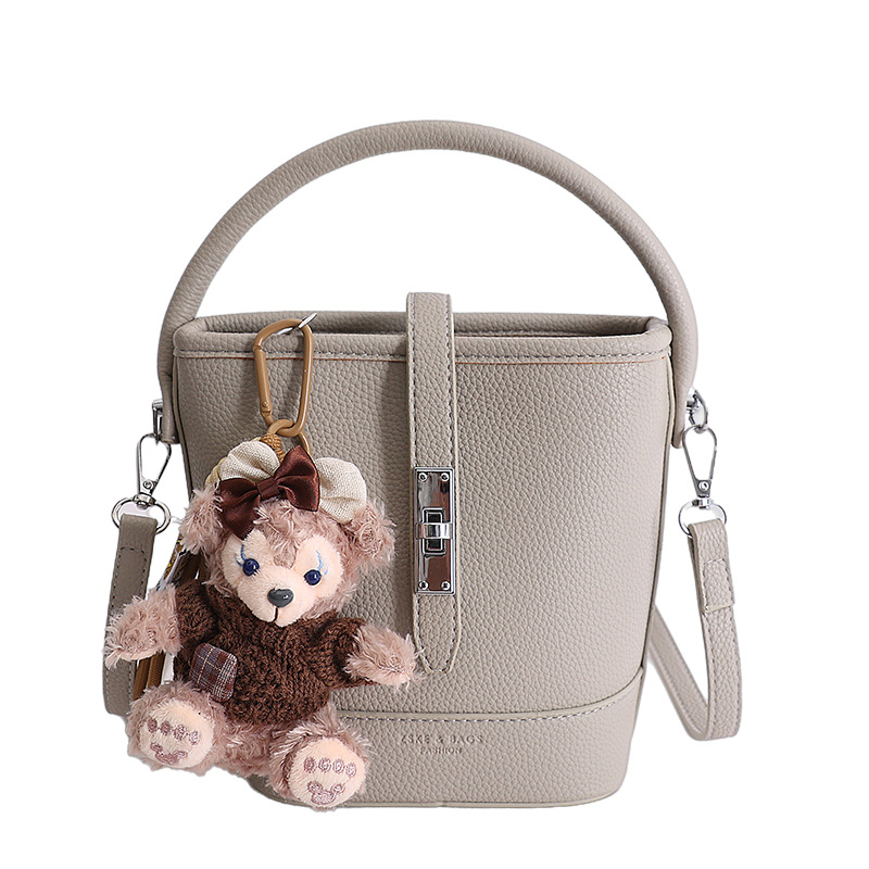 Litchi estampado bolso de cubo de mano mujer 2026 venta caliente nueva moda coreana alta textura mochila de hombro