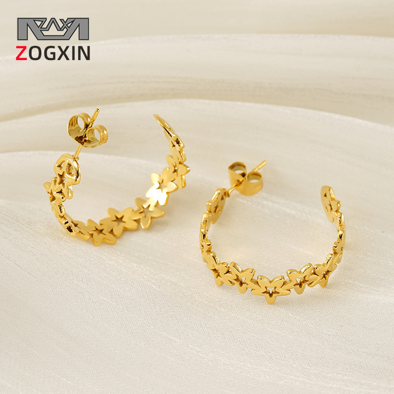 Nuevos pendientes de estrella de cinco puntas huecos de 18 quilates transfronterizos, diseño de nicho femenino, pendientes de personalidad de acero de titanio de moda simple al por mayor