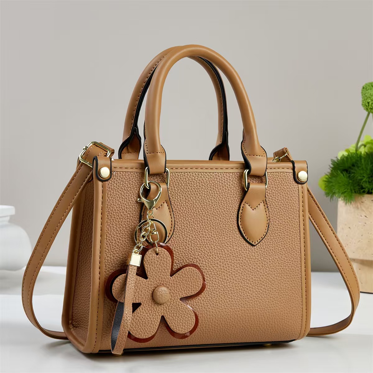 Temperamento exquisito bolso de mano mujer 2025 otoño moda versátil bolso de hombro flor decoración inclinada bolso de mano transfronterizo