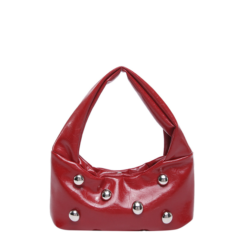 2025 primavera nueva bola remachada bolsas axila de moda nicho diseño de hombro único bolsas personales para viajar