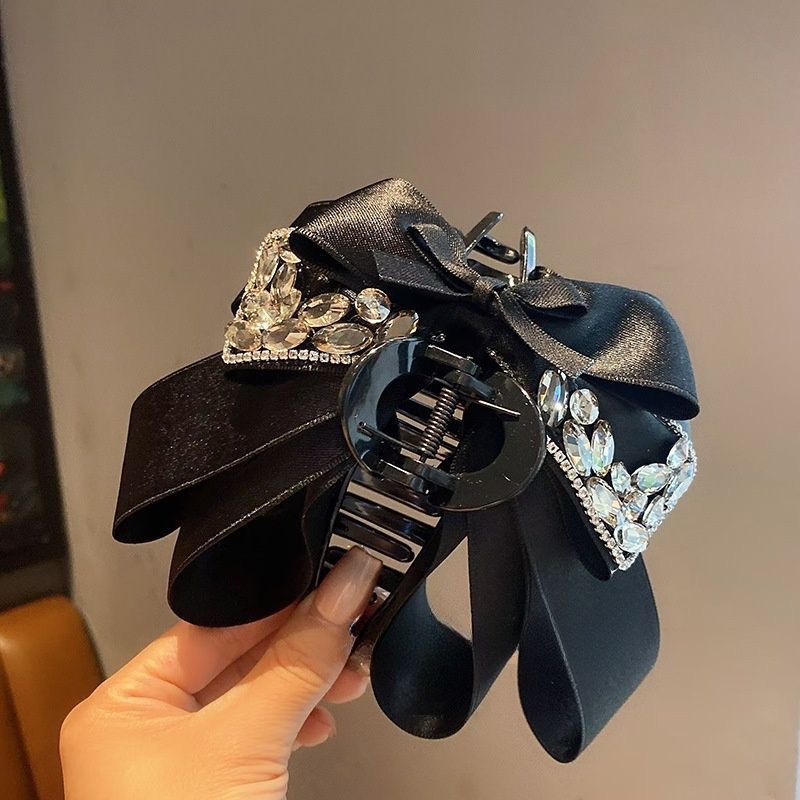 Elegant hårklämma med rosett och glittrande stenar för dam_voghion.com