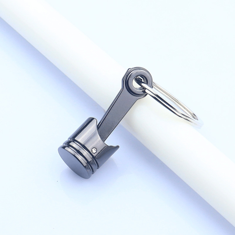 Nuevo coche transfronterizo motor pistón llavero colgante coche modificación creativa pequeño regalo letras logotipo impreso