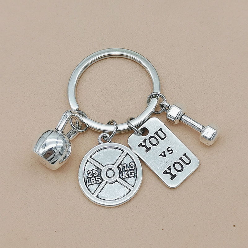 Nueva joyería europea y americana deportes poder mancuerna barra hervidor campana llavero hombres y mujeres pareja amistad llavero