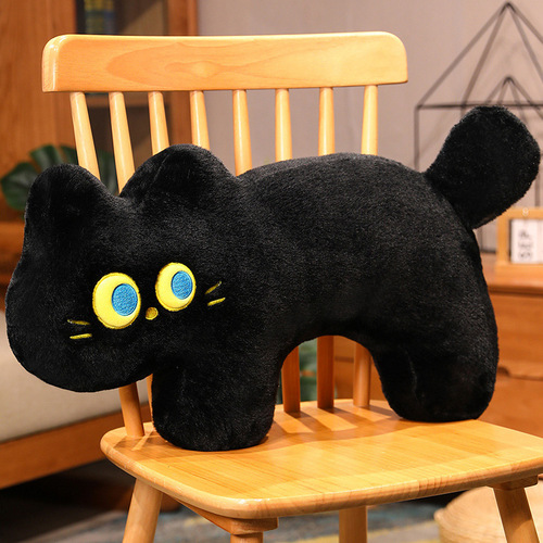 Cute black cat pillow in the bedroom for girls to sleep on and play with their mobile phone on the bed with a long pillow on the backrest and a large cushion sofa