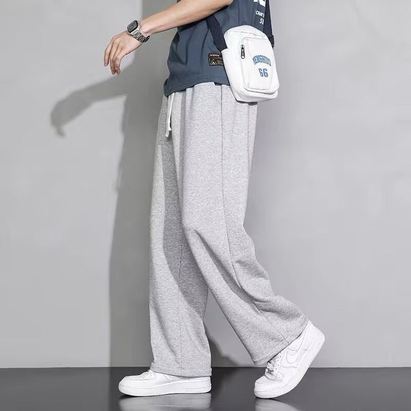 垂れ下がった感じの広腿のズボンの男性の夏のゆったりしたストレートの男性の黒色の運動の衛のズボンの春秋のタイプのカジュアルなズボンの夏