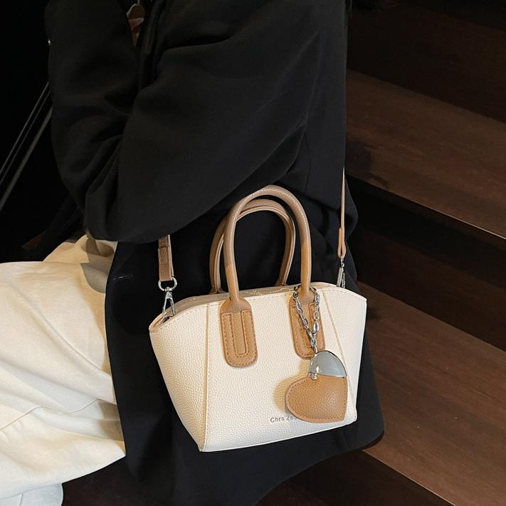 Bolso de cubo portátil de estilo caliente de moda para mujer 2025 nuevo bolso de hombro retro de nicho bolso de mensajero de moda de todo fósforo de moda