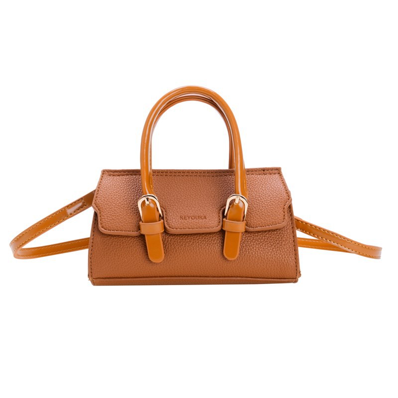 2025 nuevo bolso para niños de comercio exterior, bolso de niña popular de moda coreana, bolso de mensajero para bebé de color sólido de estilo extranjero