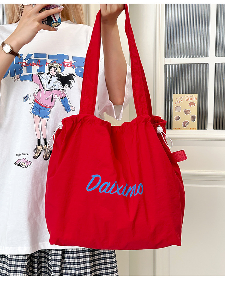Solid color large-capacity tote bag 2025 bestseller, fashionable commuting lightweight handbag, laid-back style drawstring nylon bag for women undefined