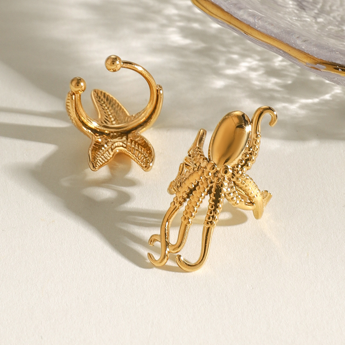 Wanxing Europa y América de acero inoxidable estrellas de mar clips de hueso de orejas de nicho de alta calidad pendientes de titanio joyas de orejas de acero pendientes transfronterizos
