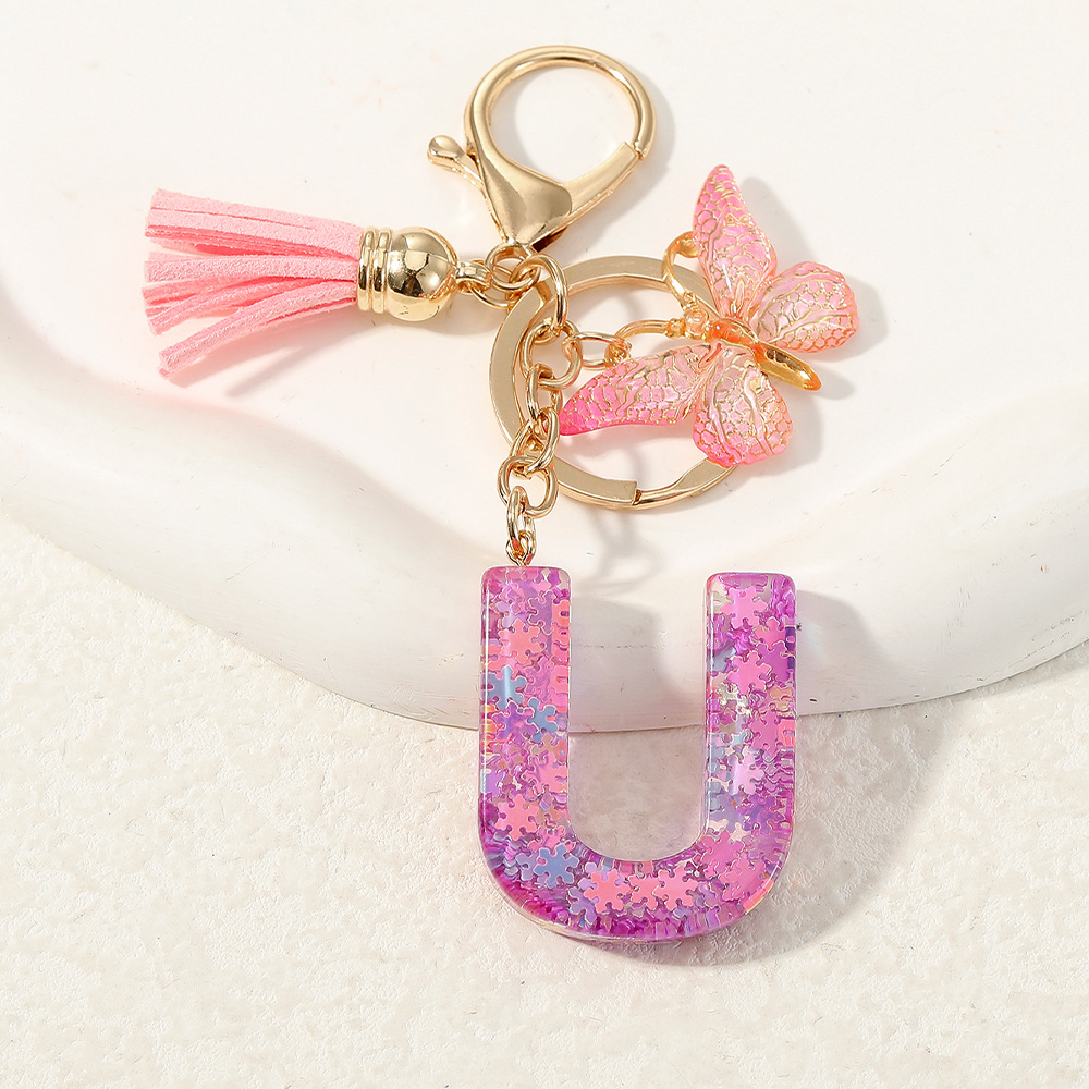 Nuevo color púrpura claro mezcla de polvo brillante letras inglesas resina llave colgante estilo simple mariposa borda colgante