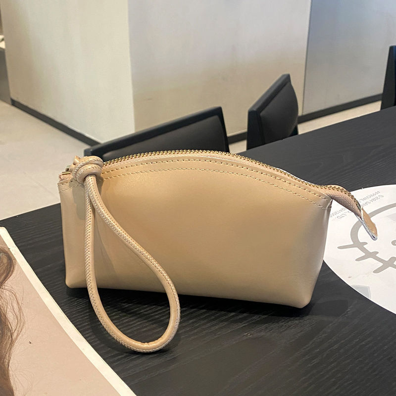 Viajes de moda primavera y verano nuevo nicho de diseño pu piel retrógrada elegante portátil bolso de bollo de gran capacidad transfronterizo para mujeres