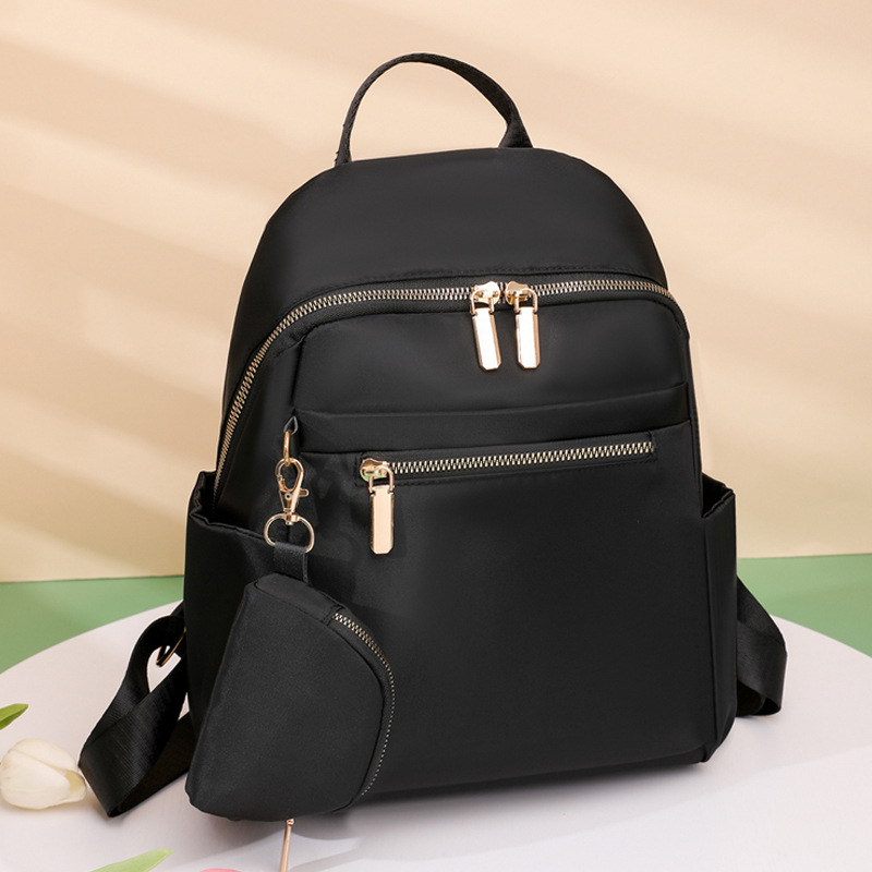 Comercio exterior al por mayor 2023 nueva mochila de nailon para mujer coreana, mochila de viaje al aire libre de todo fósforo de moda