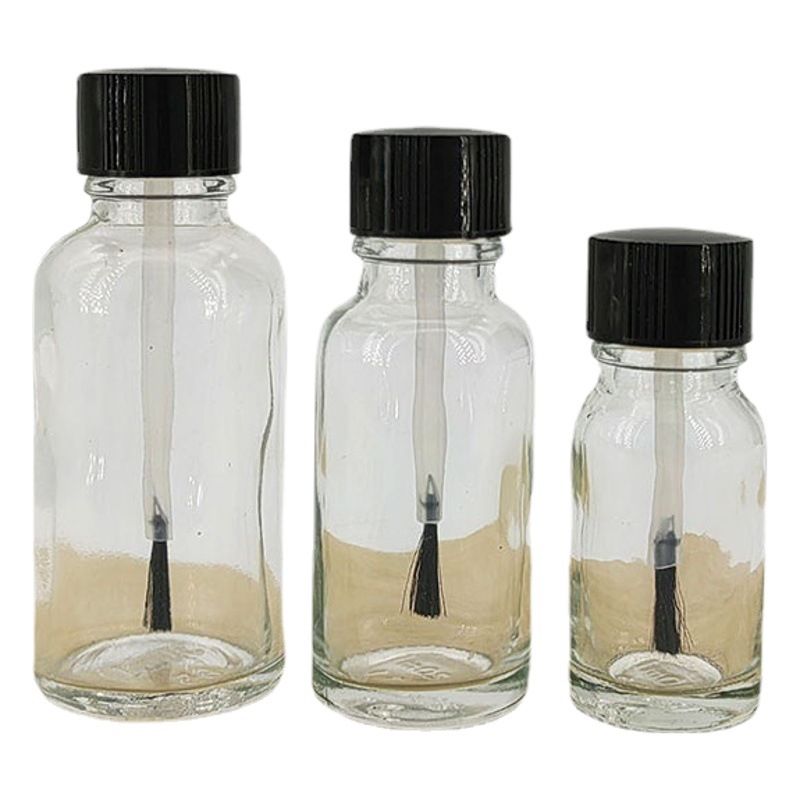 Venta al por mayor 30ml botella de aceite esencial de vidrio transparente 20ml botella de pegamento cepillo 50ml botella de esmalte de uñas