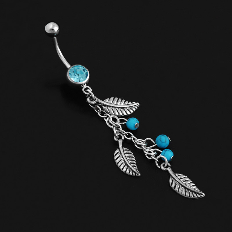 Piercing do pupíku s pírkem a tyrkysem_voghion.com