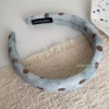 Brown dot hoop on blue background