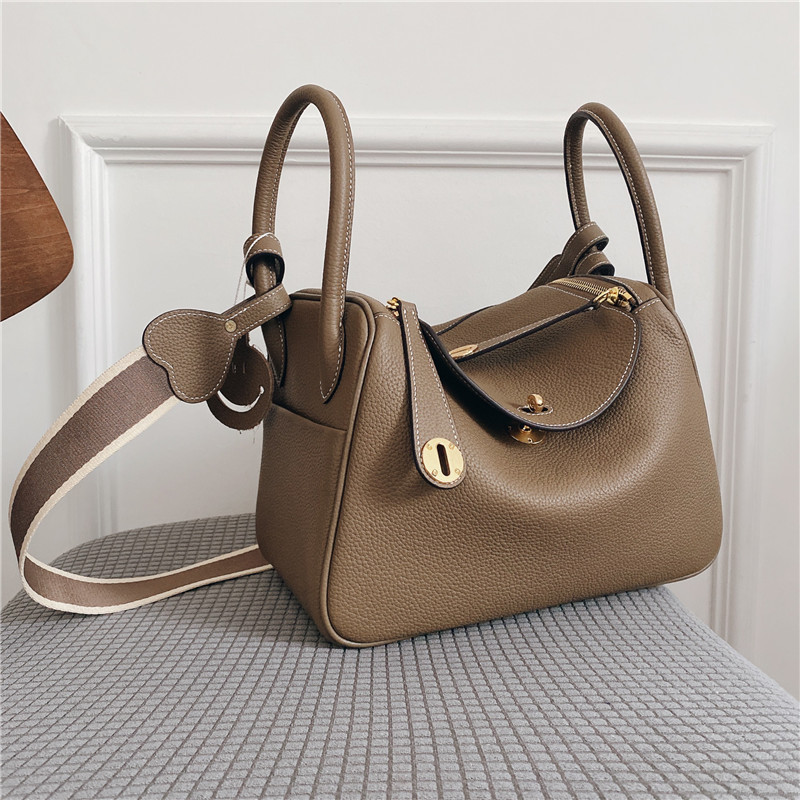 Bolsos de cuero Lindy de piel de vaca con togo de primera capa 2025 Bolsos de cubo retro de estilo europeo y americano Bolsos portátiles de moda